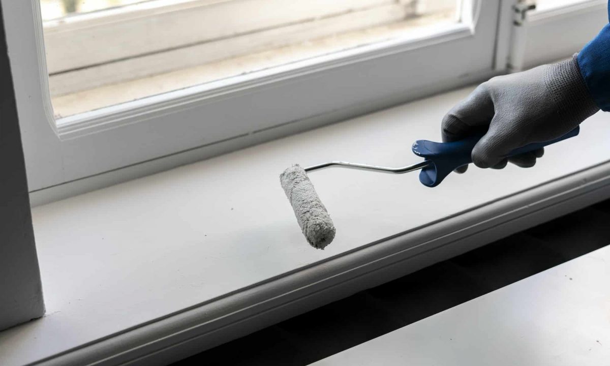a professional painter doing his job holding a paint roller